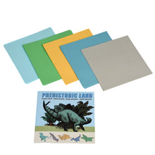 Load image into Gallery viewer, 5 differently coloured stacks of origami paper (light blue, green, yellow, darker blue and grey) and the booklet.
