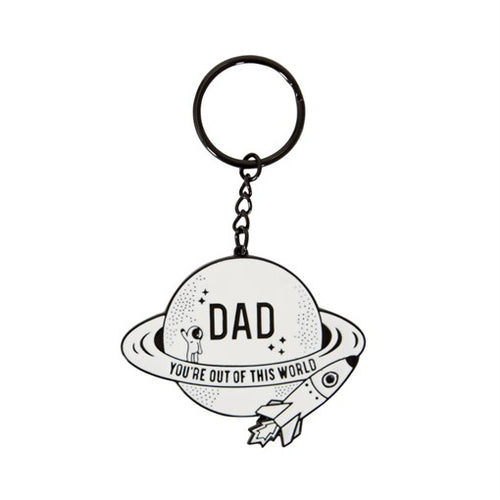 Keyring with a white saturn, astronaut standing on the rings, and a rocket. Keyring reads across the planet 