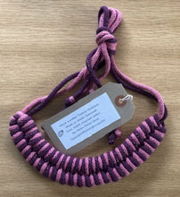 Load image into Gallery viewer, Rose and Plum (Pink and purple) necklace is tied together with a large knot. 
