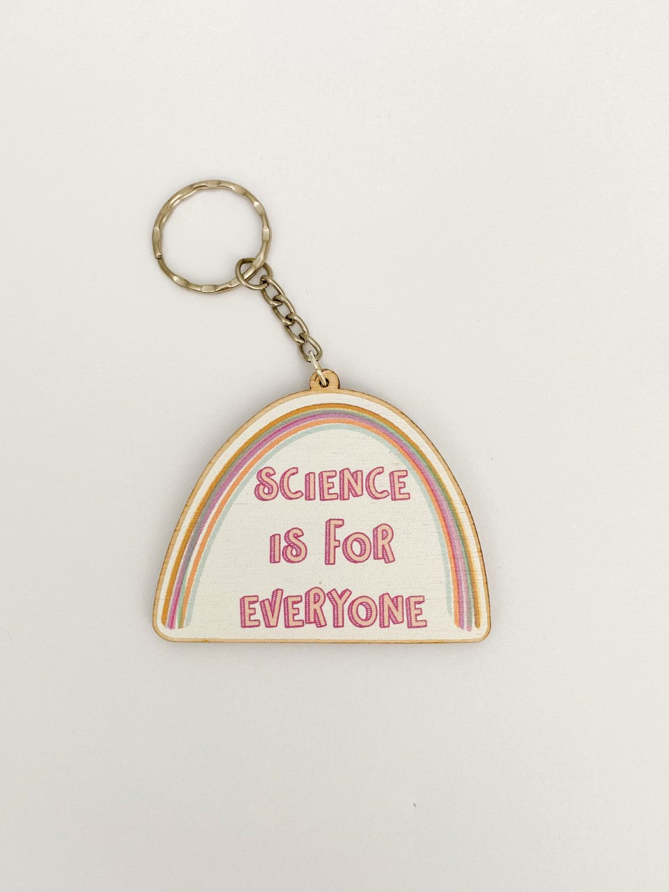 Keyring reads 'Science is for everyone'. Shape of keyring is half an oval. Above the words is a rainbow. A small chain leads to a keyring attachment. 