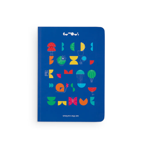Blue notebooks shows the We The Curious alphabet with colourful designs and drawings. At the top is the We The Curious logo in white, and underneath the design is the name 