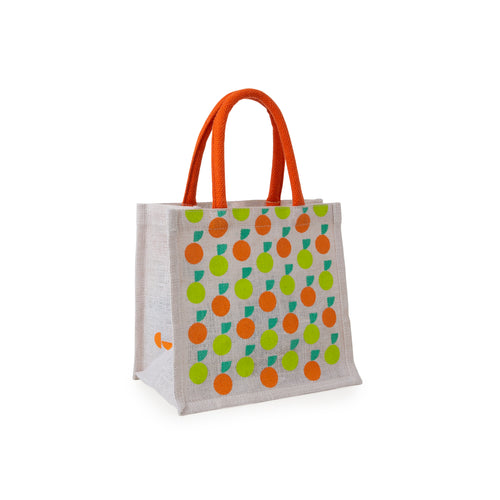 Small jute bag features lime and mandarin orange designs. Handles are orange. Side panel shows the We The Curious logo. 