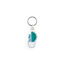 Load image into Gallery viewer, Keyring design shows green cactus in a white pot, with We The Curious logo to the side of the cactus. 
