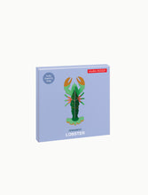 Load image into Gallery viewer, Lobster packaging is purple. Lobster is green. 

