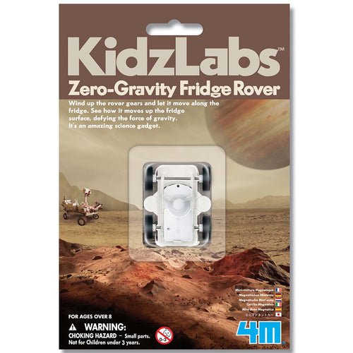 Packaging is brown card sleeve with illustration of Mars with Jupiter in the background. Plastic window holds the rover to the packaging. Packaging reads 'KidzLabs zero-gravity fridge rover. Wind up the rover gears and let it move along the fridge. See how it moves up the fridge surface, defying the force of gravity. It's an amazing science gadget'. 