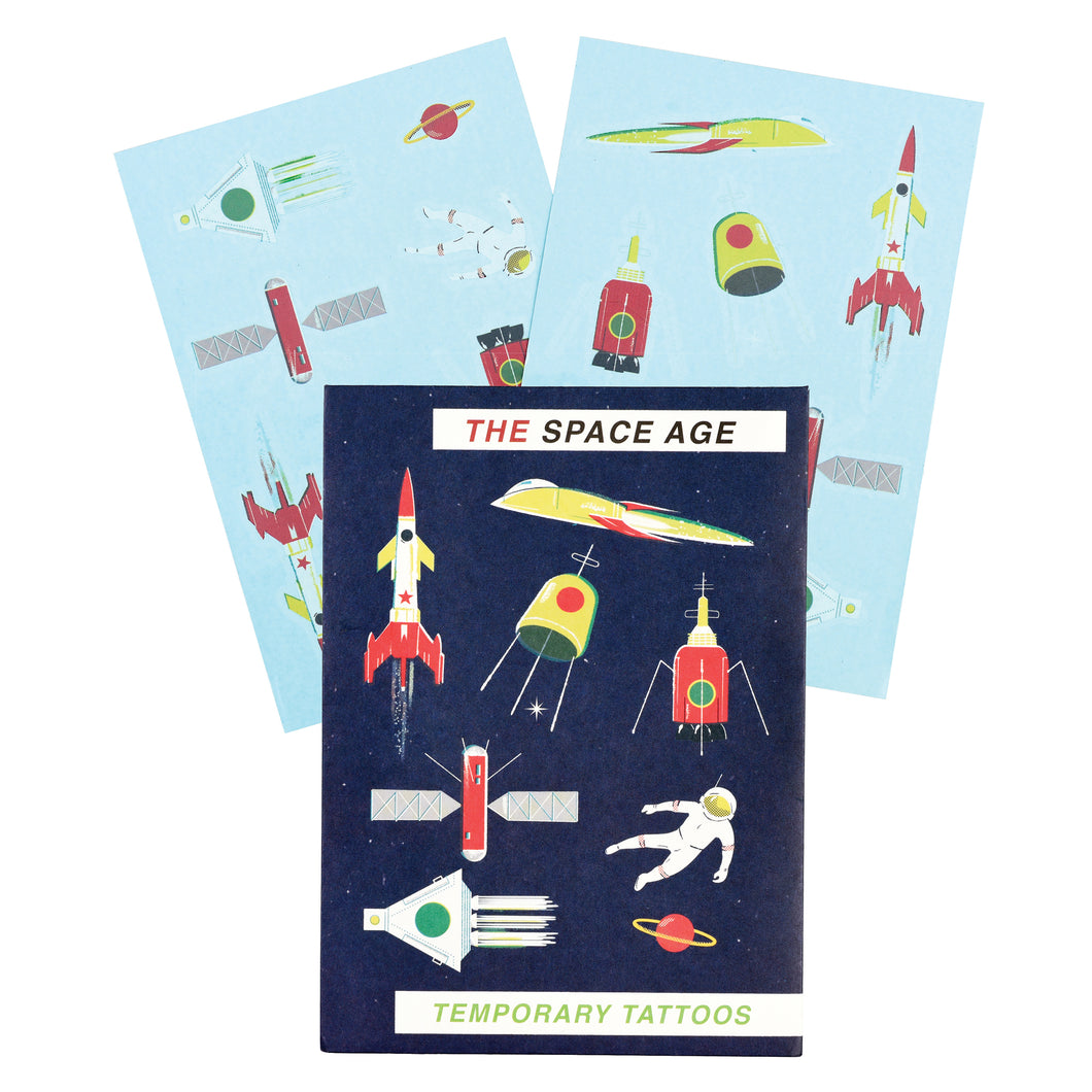 Two sheets of tattoos behind dark blue packaging. Packaging reads 'the space age temporary tattoos' with colourful illustrations.