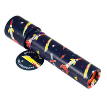 Load image into Gallery viewer, Blue tube with colourful illustrations of white, yellow and red rockets, planets and stars. A tag is attached with a purple band. On one end of the tube is a small hole.
