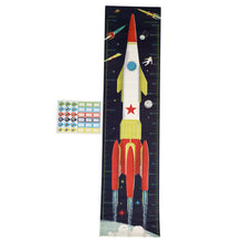 Load image into Gallery viewer, Fully extended height chart with a set of stickers. Stickers show 3 circle stickers and 3 blank rectangular stickers in green, red, dark blue and yellow, and 6 of each in light blue. Design on the height chart is dark navy blue with white and red rocket with yellow accents blasting off. Smaller illustrations of rockets, meteor, moon, astronaut, and planet are in the background.

