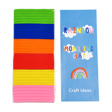 Load image into Gallery viewer, Clay lined up vertically next to the craft ideas sheet. Paper is blue with &quot;rainbow modelling clay craft ideas&quot;, illustrated white clouds and a rainbow with red, pink, yellow and green arches.
