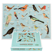 Load image into Gallery viewer, Completed birds puzzle with box propped in front. Puzzle is blue with colourful illustrations of birds. Box is blue.
