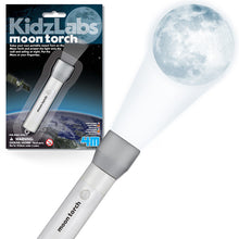 Load image into Gallery viewer, Packaging in top left with moon torch projecting a full moon in the centre of the photo. &#39;Moon torch&#39; is written on the white body of the torch, next to a button. 
