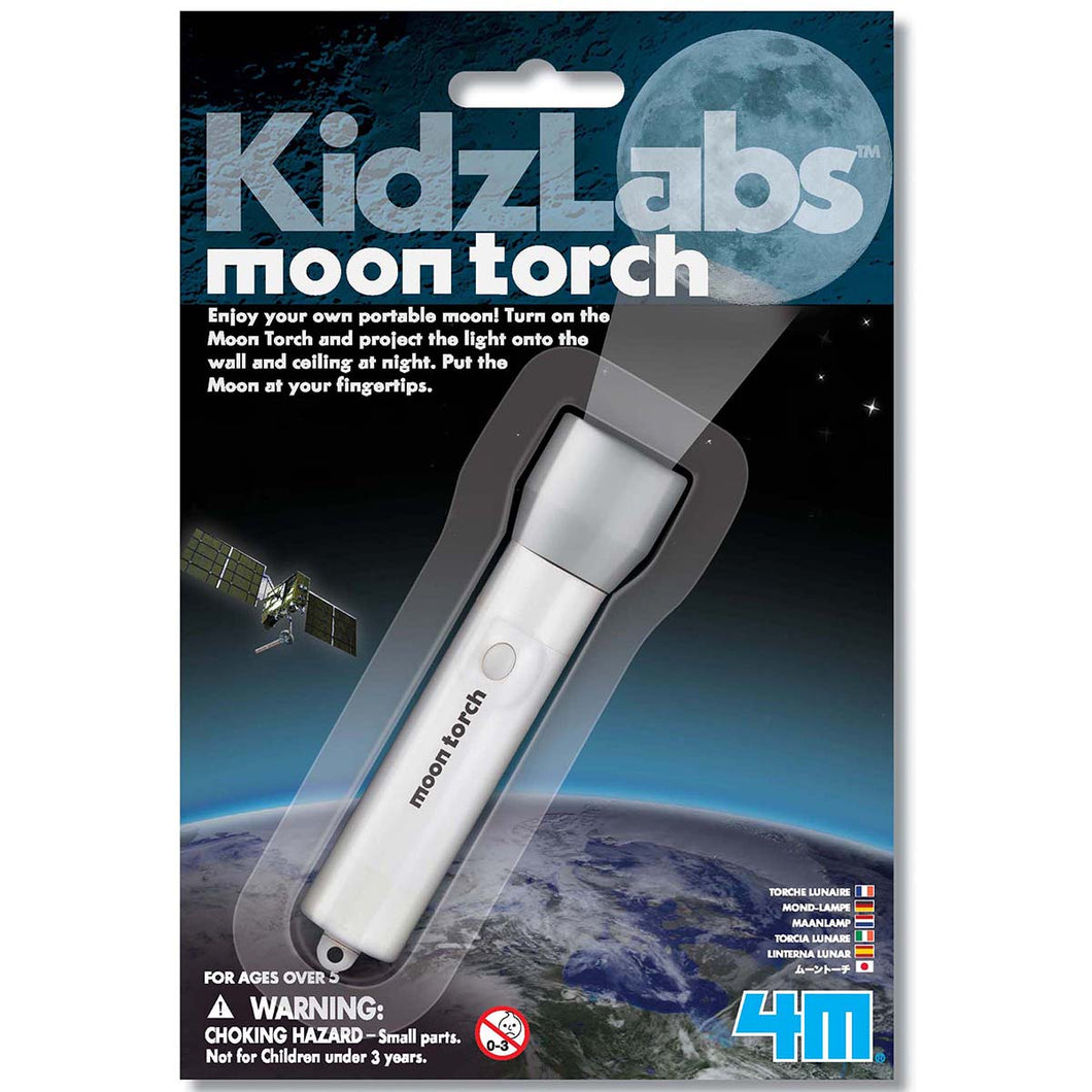 Packaging is blue with image of a satellite floating above Earth. Moon torch sits behind a plastic sleeve. Packaging reads 'KidzLabs moon torch. enjoy your own portable moon! Turn on the moon torch and project the light onto the wall & ceiling at night. Put the moon at your fingertips.' 