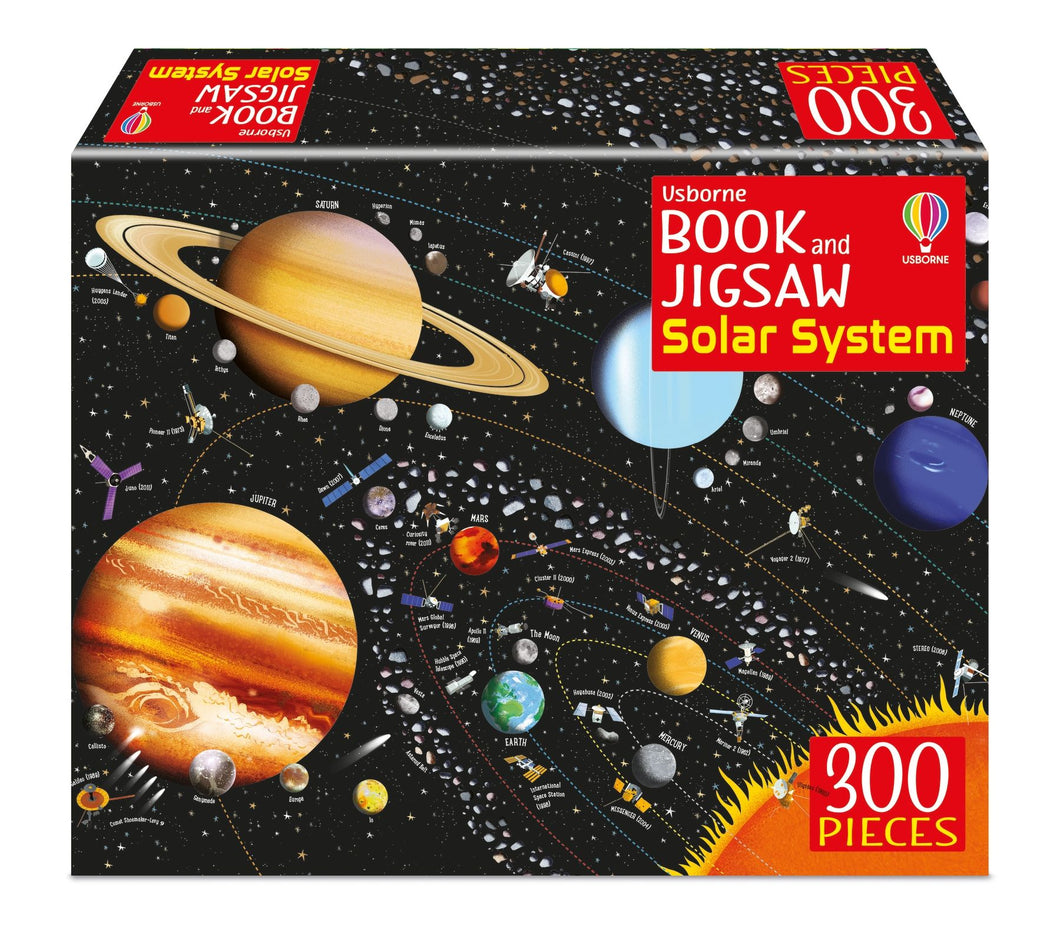 Front of box shows puzzle image. Background is black space with white stars. Planets, satelites, moons & the asteroid belt orbit the sun on their own lines. Each of these are labeled.