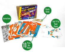 Load image into Gallery viewer, Contents of the box in front of the cardboard box with purple sleeves. Contents include instructions, 10 press-out sheets, fold&#39;n&#39;fly paper planes and 4 elastic bands. 
