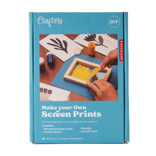 Cardboard box is blue with image of someone screenprinting a yellow flower onto blue paper. Packaging reads 'crafters, diy, make your own screen prints, screen print your own designs on any surface. contains wooden printing frame, acetate sheets, stencils, acryllic paint.'