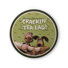 Load image into Gallery viewer, Green coaster shows Wallace &amp; Gromit clinking tea cups. It reads &#39;Cracking tea lad!&#39; across the top. 
