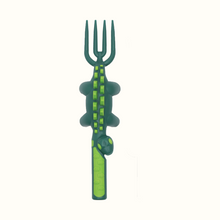 Load image into Gallery viewer, Fork is vertical with tines pointed upward. Fork is dark green with light green markings (dinosaur spines, eyes and grippy section of handle). 
