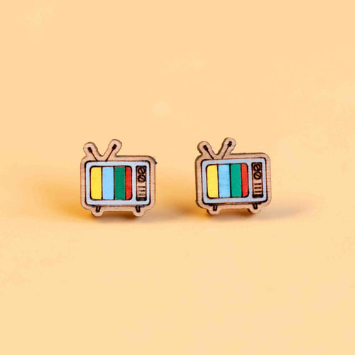 Two wooden rectangle earrings shaped like old standing TVs with aerials and dials on the right of the screen. The screens are vertical stripes of yellow, blue, green and red. 