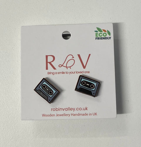 Two blue hand-painted cassette tape earrings on a white card. Card reads 'RV, bring a smile to your loved one. robinvalley.co.uk, wooden jewellery handmade in UK, eco friendly.' 