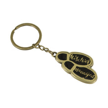 Load image into Gallery viewer, Keyring has gold coloured metal footprints with black soles and &#39;mischief managed&#39; written in gold script letters. Chain and loop are also gold coloured. 
