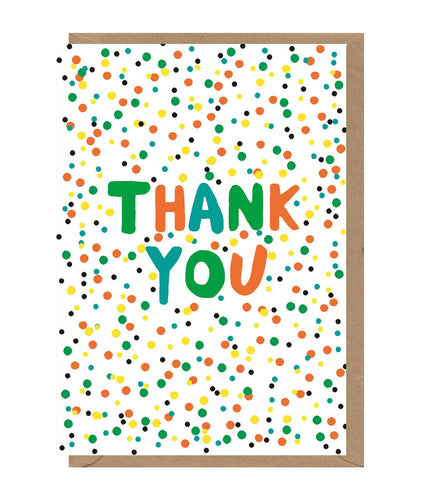 White card with colourful dots and 'thank you' in green, orange and blue letters. Card sits on brown envelope. 