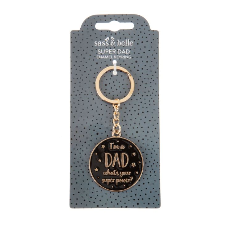 Keyring is gold coloured with a black round disk. On the disk are gold stars and the words 