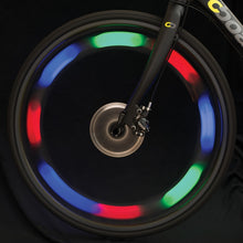 Load image into Gallery viewer, spoke light on a bike wheel while rotating shows flashing blue, green and red lights. 
