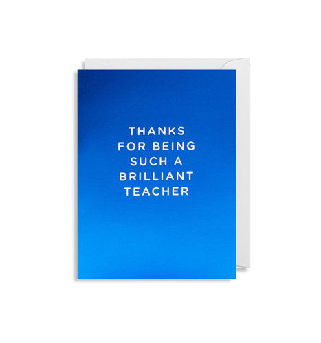 Metallic blue card with white envelope tucked inside. In white capital letters, the card reads 'thanks for being such a brilliant teacher'.