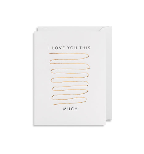 Card reads 'I love you this...much' with a gold line winding back and forth between 'this' and 'much'. Tucked into the card is a white envelope.