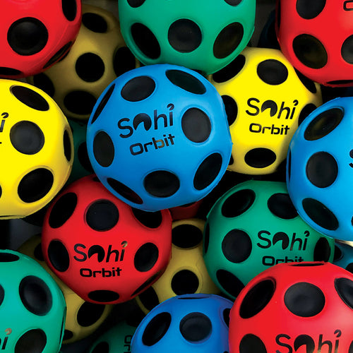 Pile of Sohi orbit balls in blue, green, yellow and red. Each ball has several black shallow dips covering the surface, and has 'sohi orbit' written in black. 
