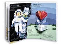 Load image into Gallery viewer, Book propped open and showing inside spread. Left page shows white male astronaut in a suit with the title &#39;on a space walk&#39;. Right page shows &#39;end of mission&#39; with a capsule being lowered to earth with a parachute. 
