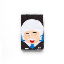 Load image into Gallery viewer, Folded black sock shows a face on the toe part with white hair, black jumper, and blue tie. Face is sticking their tongue out.
