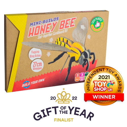 Packaging for Honey Bee Kit with 2 graphics in front. 1 is a gold coin with 'independent toy awards 2021 toy shop uk winner' the other is for '2022 Gift of the Year finalist'. Packaging is brown card with image of assembled bee. Decal reads 'Less plastic'