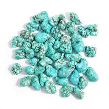 Load image into Gallery viewer, Pile of turquoise turquerenite gemstones with brown lines. 
