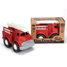 Load image into Gallery viewer, One fire truck inside a cardboard box with cut-out to show the truck. Another truck is displayed outside the box with the ladder flat. Fire engine is red with black tired, white rims, grey grill, white ladders and black cab interior.
