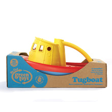 Load image into Gallery viewer, Side view of tugboat in cardboard packaging, wrapping the bottom of the boat. Packaging reads &#39;No BPA phthalates PVC. My first Green toys. 100% recycled milk jugs. 6 months+. Tugboat.&#39;
