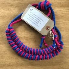 Fuschia and blue necklace is tied at the top with a large knot. 
