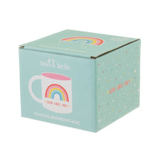 Load image into Gallery viewer, Packaging is turquoise box with illustration of the mug. Box shows sass&amp;belle logo and reads &quot;Chasing Rainbows mug&quot;. The top of the box has a rainbow illustration and the side shows illustrated stars background with &quot;good vibes only&quot; in capital letters.
