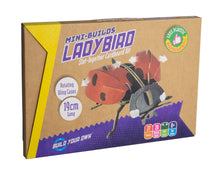 Load image into Gallery viewer, Packaging of ladybird kit is brown cardboard with image of the ladybird. Arrows show that the wings move side to side. Packaging reads &#39;mini-builds ladybird slot-together cardboard kit, rotating wing cases, 19cm long, build your own, less plastic #paperfantastic&#39;. 
