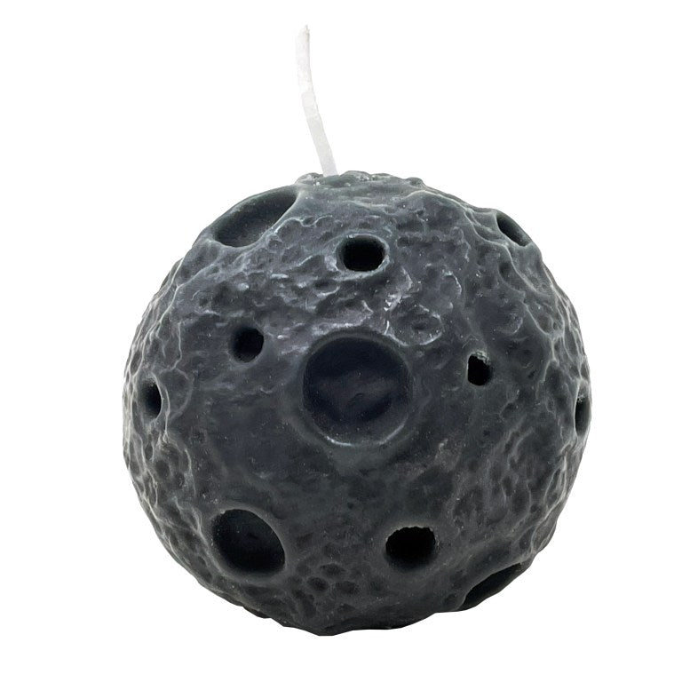 Round grey candle with craters and a white wick.
