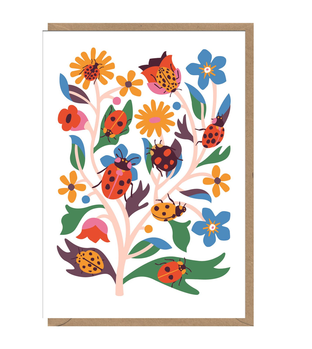 White card with brown kraft envelope tucked inside. Card has illustrations of ladybirds in red, yellow and black climbing over flowers and leaves.