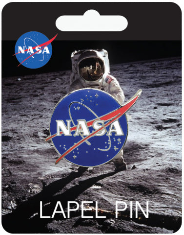 NASA pin is blue with red 'V' at an angle, and a grey circle going around 'NASA' written in capital white letters. On the blue background are small silver stars. Badge attached to card. Card shows image of an astronaut on the moon with 'lapel pin' written below. NASA logo is in top left.