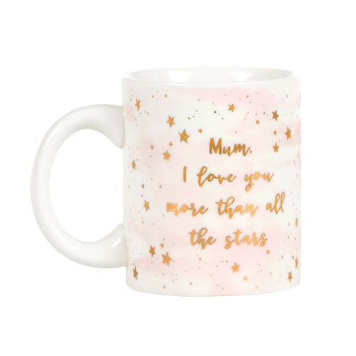 White mug with pink details, gold stars and lettering. Words read in cursive 'Mum, I love you more than all the stars' 