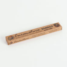 Load image into Gallery viewer, Cardboard box packaging reads &quot;Curanatura bamboo toothbrush, bamboo, extra soft&quot; and has a picture of Earth with &quot;eco friendly&quot; stamped over it. 
