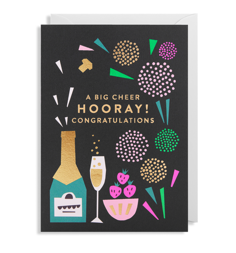 Black card with white envelope tucked inside. Colourful and occassionally foiled illustrations on the cover include fireworks, champagne bottle and glass, strawberries in a bowl. In capital letters and gold foil, the card reads 'A big cheer, Hooray! Congratulations'