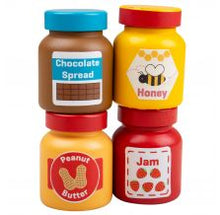 Load image into Gallery viewer, 4 spread jars stacked. Peanut butter jar is yellow with red label and lid, Jam is red with white label reading Jam and pictures of strawberries, Honey is yellow, red lidded, and with white label featuring a bee, Chocolate spread is brown with blue lid featuring picture of chocolate bar. 
