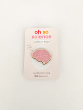 Load image into Gallery viewer, Brain wooden pin badge with pink colour and lines. Pin badge is shaped like the brain. Pin badge is attached to a backer that reads &#39;oh so science wooden pin badge&#39; and &#39;I&#39;m eco friendly&#39; with website &amp; social media details.
