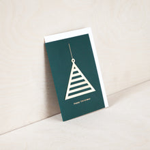 Load image into Gallery viewer, Green card with brass tree ornament. Underneath reads &quot;happy Christmas&quot; in gold foil. White envelope peaks out from inside the card. 
