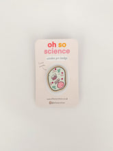 Load image into Gallery viewer, Cell pin badge is oval shaped with wonky edges. Drawing of the inside of a cell with black line around it. Pin badge is attached to a backer that reads &#39;oh so science wooden pin badge&#39; and &#39;I&#39;m eco friendly&#39; with website &amp; social media details.
