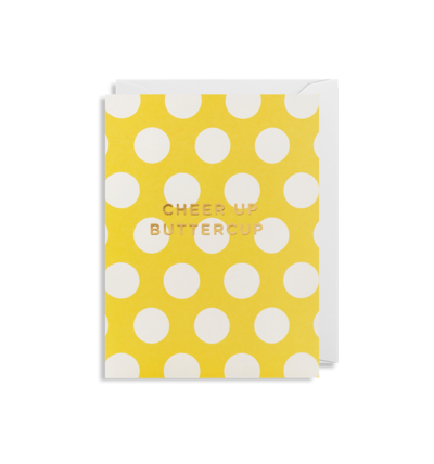 Yellow card with white circles with white envelope tucked inside. In capital gold lettering card reads 'cheer up buttercup'.